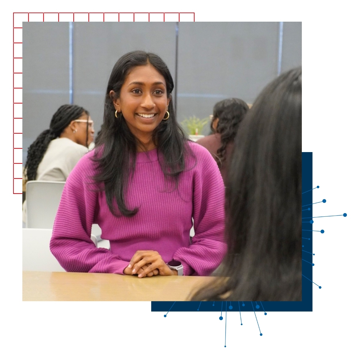 University of Kansas business student Chiara Fernando converses with another student across a table at a business school event.