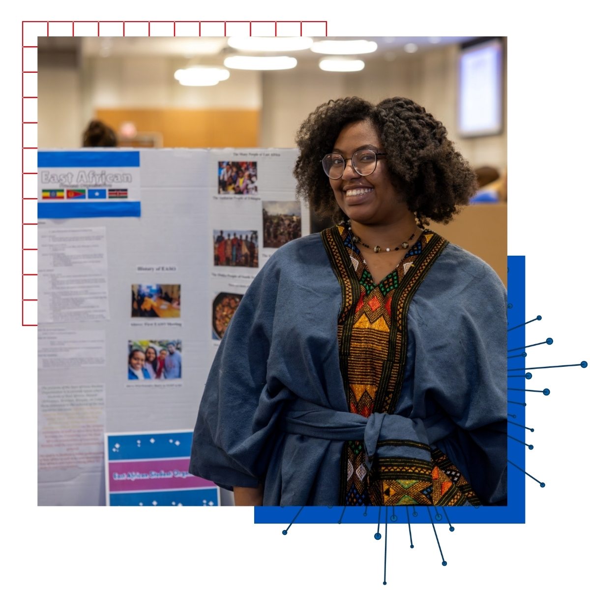 A student stands in front of a board showcasing her East African heritage at KU's International Jayhawk Festival.