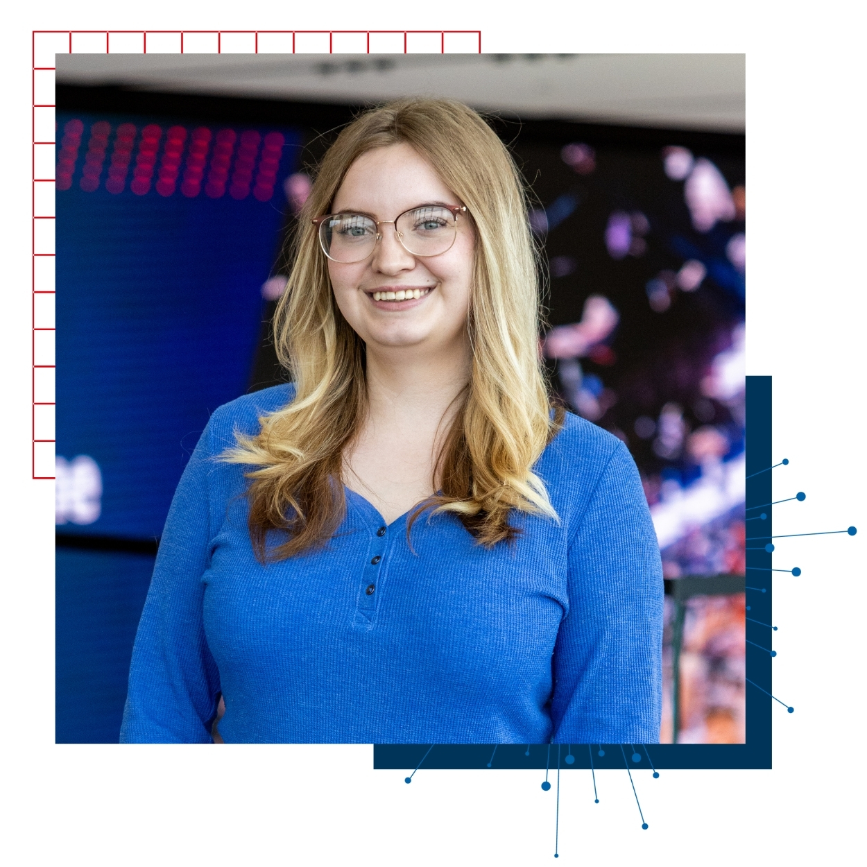 University of Kansas transfer student Lexie Huske poses for a portrait at the Jayhawk Welcome Center, wearing a blue shirt. 