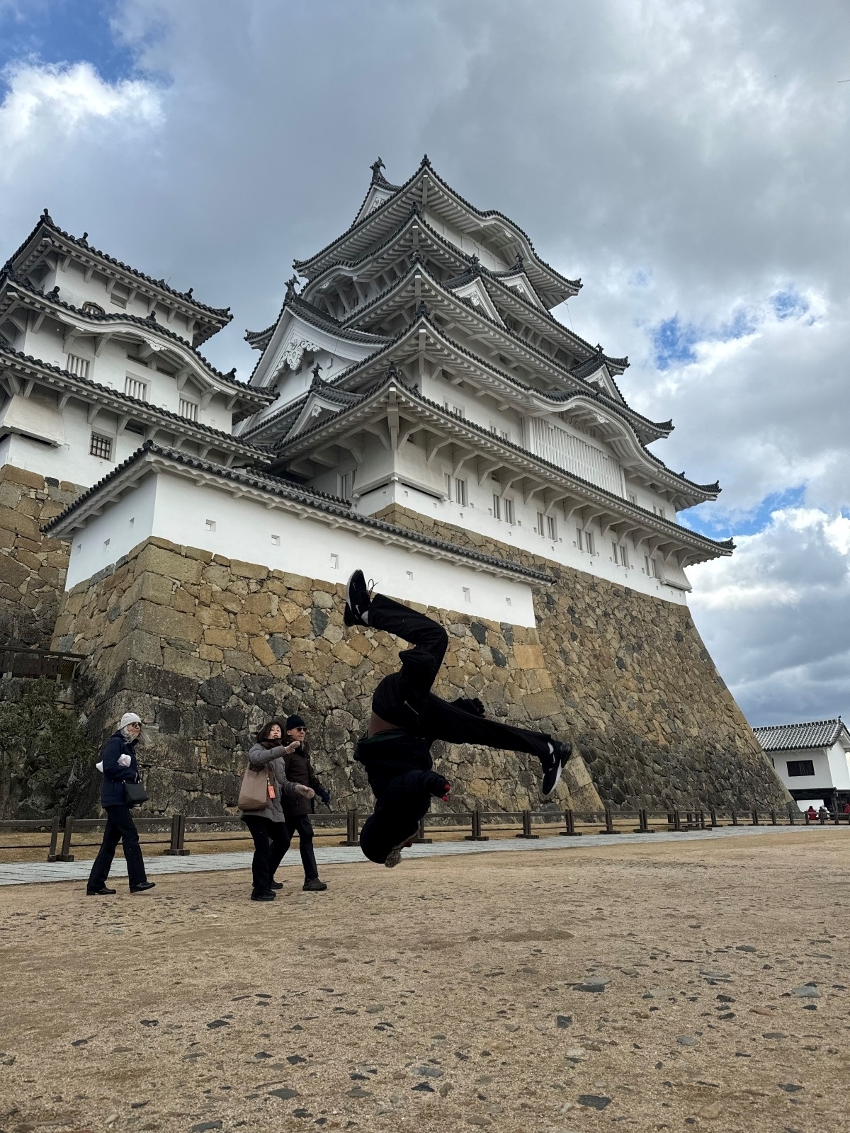 University of Kansas architecture student James Price flips in front of a building in Japan on a study abroad trip to Asia.