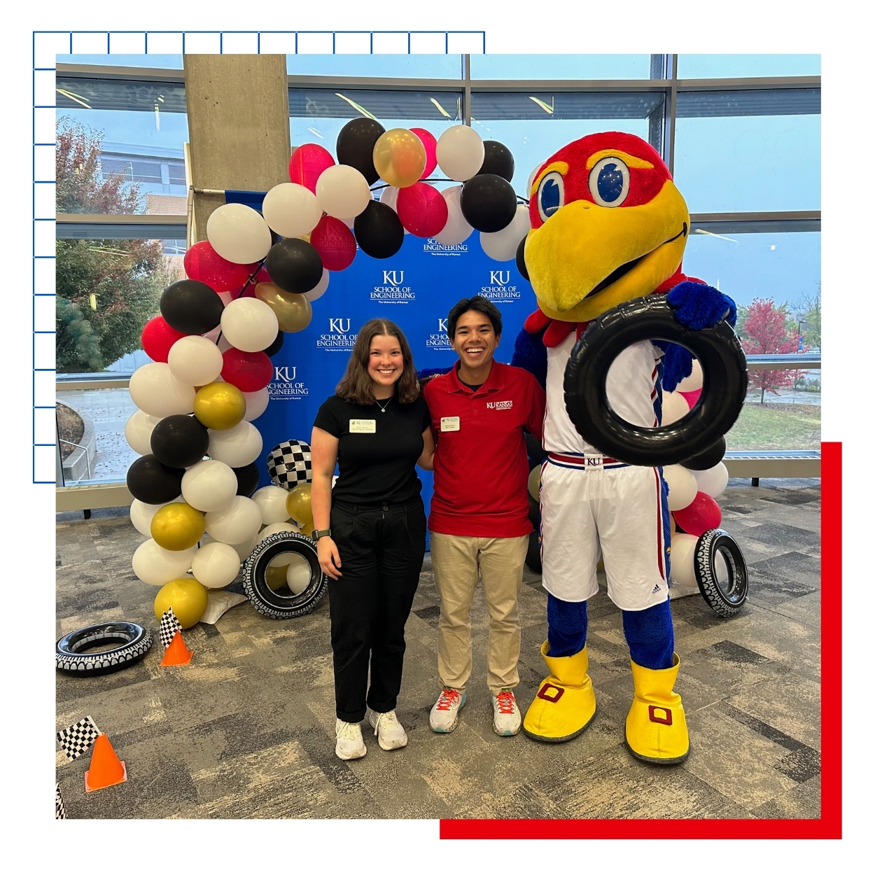 University of Kansas SELF engineering fellows pose with the Jayhawk mascot at a high school design event.