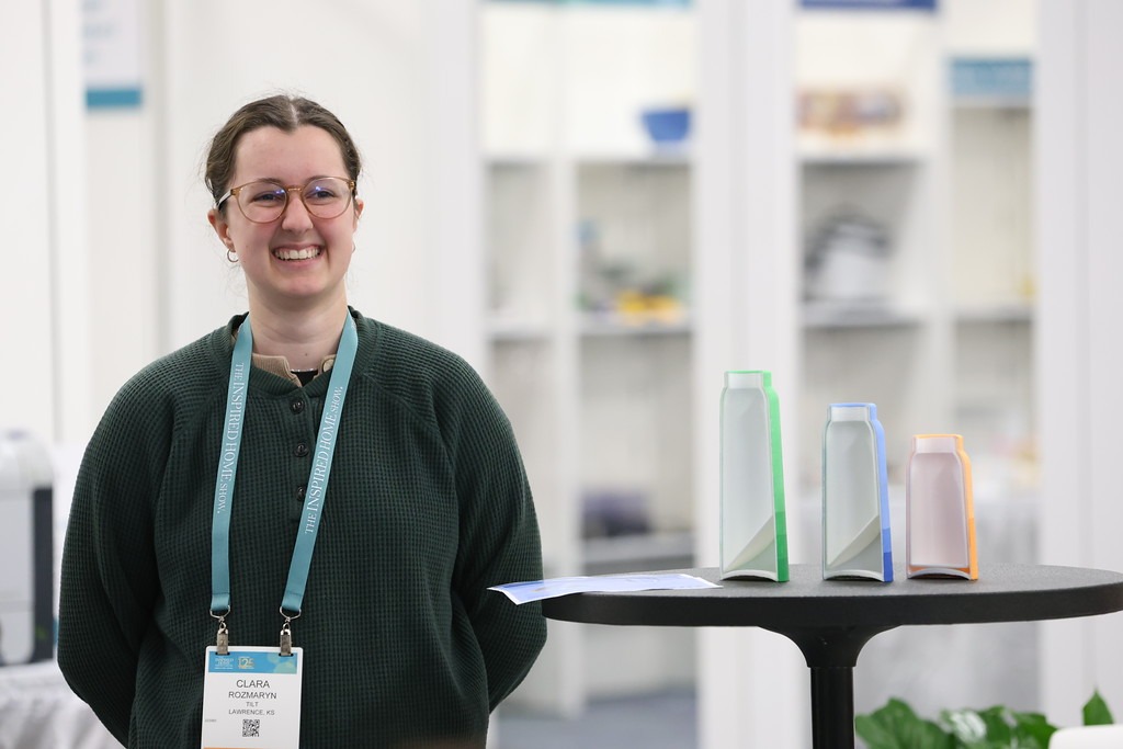 KU student Clara Rozmaryn stands next to her award-winning housewares design project, a cleaning system of bottles entitled "Tilt".