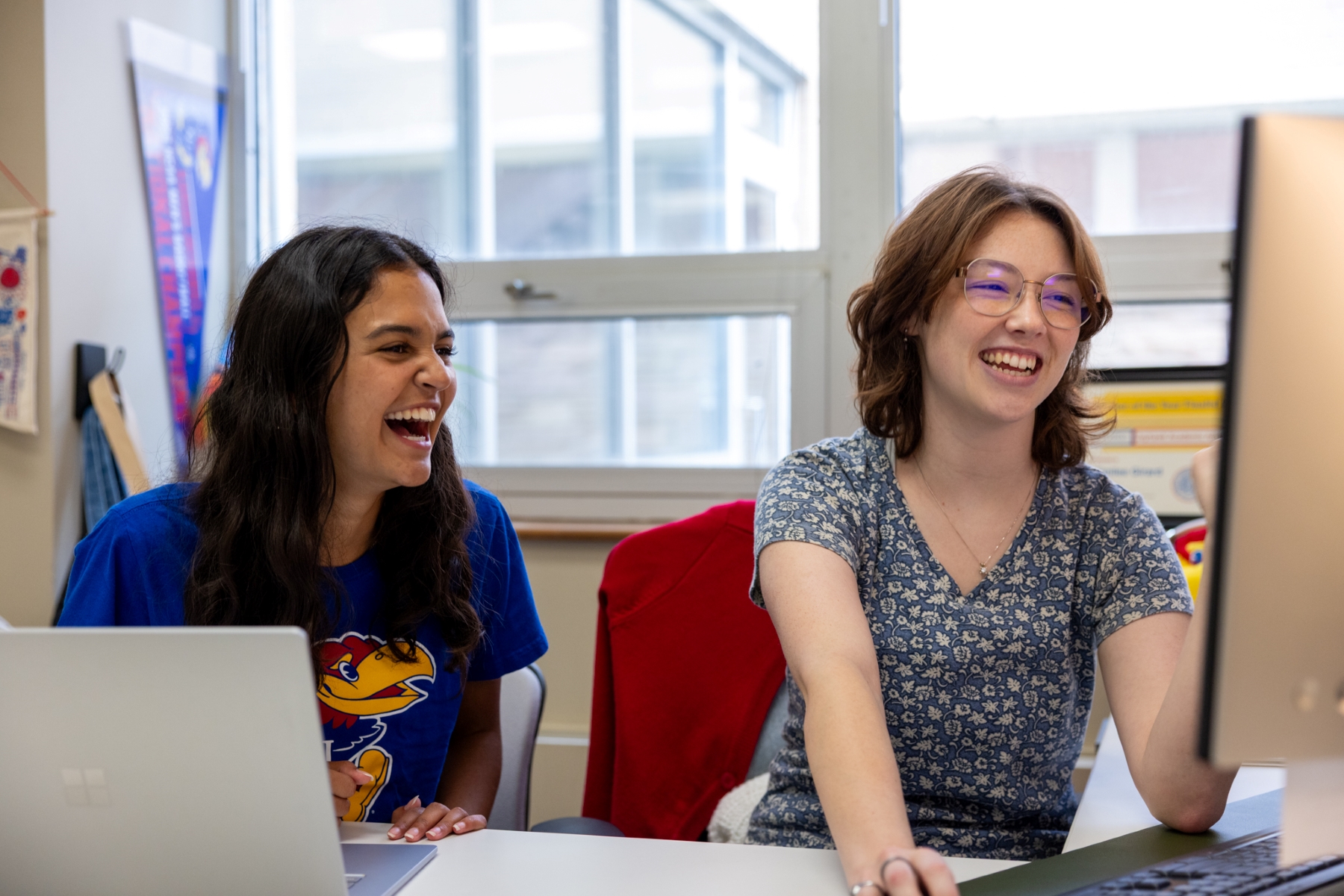 University of Kansas Honors Engineering Advisor Emilee Girard (a psychology major who is now pursuing a master’s in public administration) chats with KU student Leah Pal in her office.