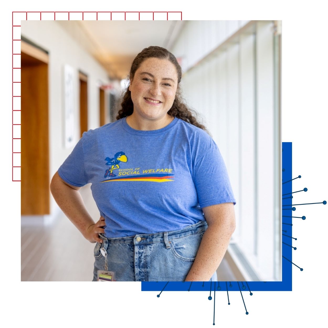 University of Kansas alumna Sydnee Bradley poses for a portrait in a blue KU School of Social Welfare t-shirt. 