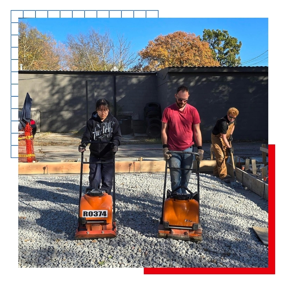 University of Kansas architecture students work on pouring concrete at the 2025 Studio 804 build. 