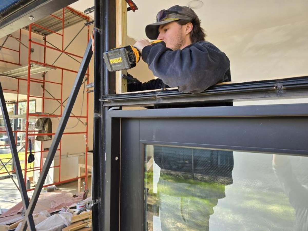 University of Kansas Studio 804 student Alex Meyer works on the interior of the 2025 home build. 