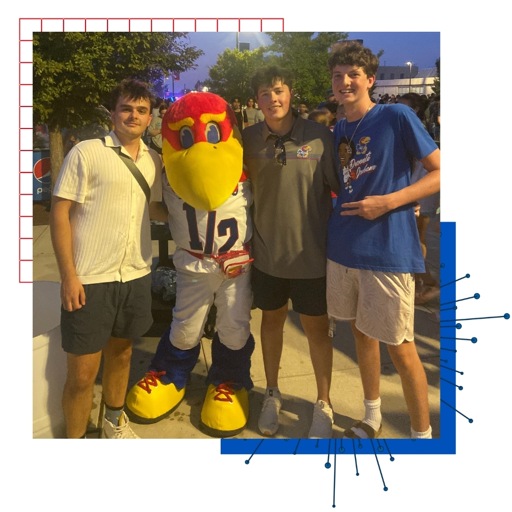 University of Kansas student Oscar Sanchez Christensen and friends post with Baby Jay, the KU mascot.