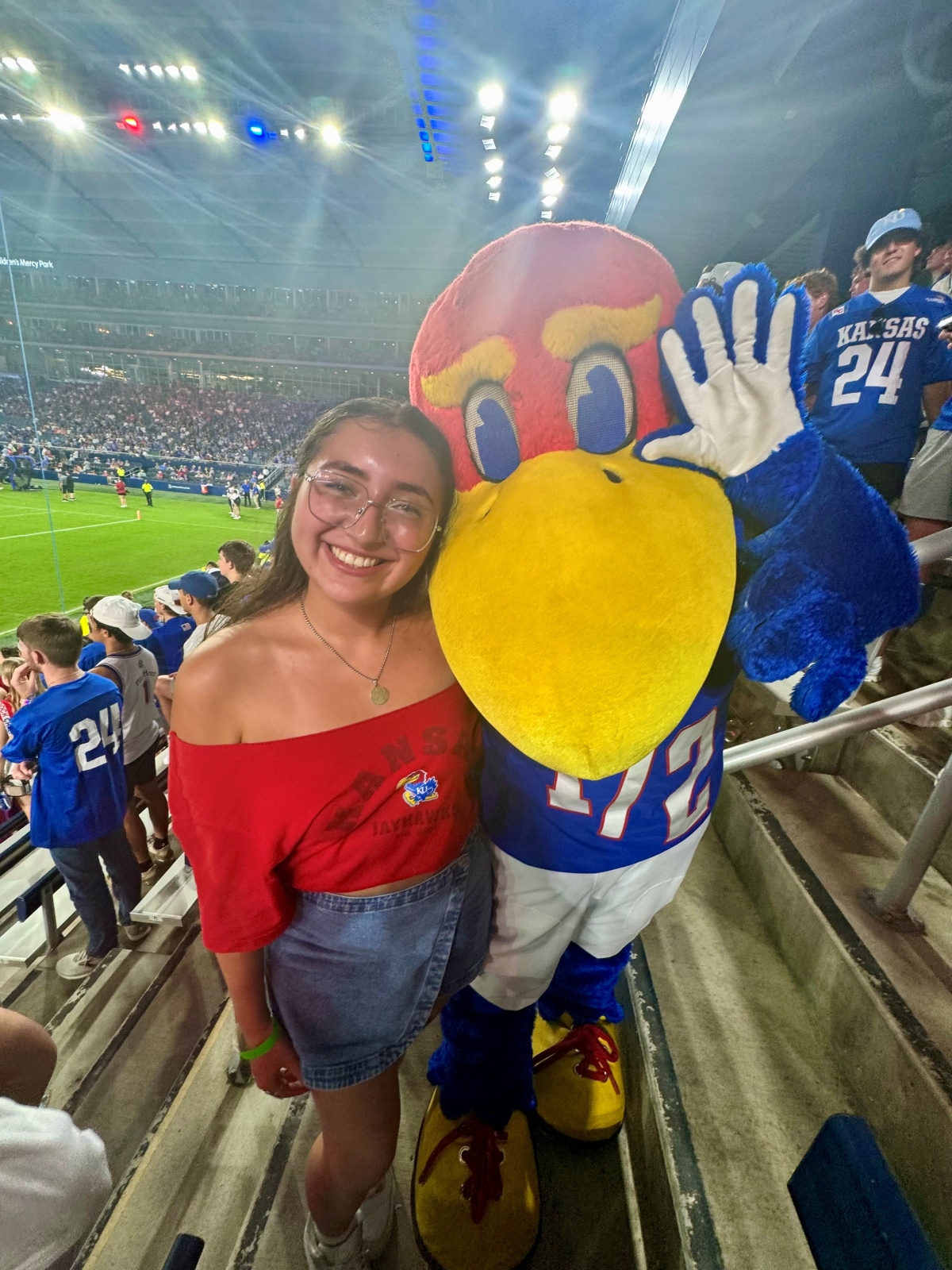 University of Kansas student Valeria Solis poses with Baby Jay at a football game.