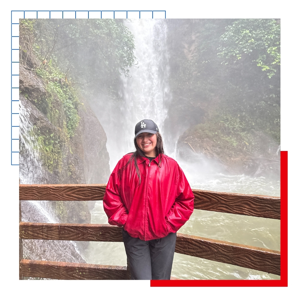 University of Kansas student Valeria Solis in front of a waterfall in Costa Rica on a study abroad trip.