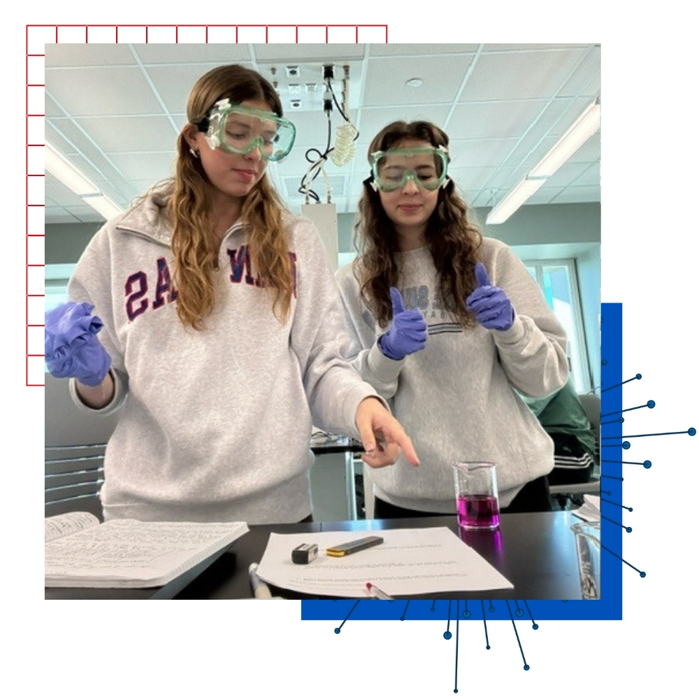 University of Kansas student Celeste Ruisinger and her lab partner wearing goggles in a classroom setting. 