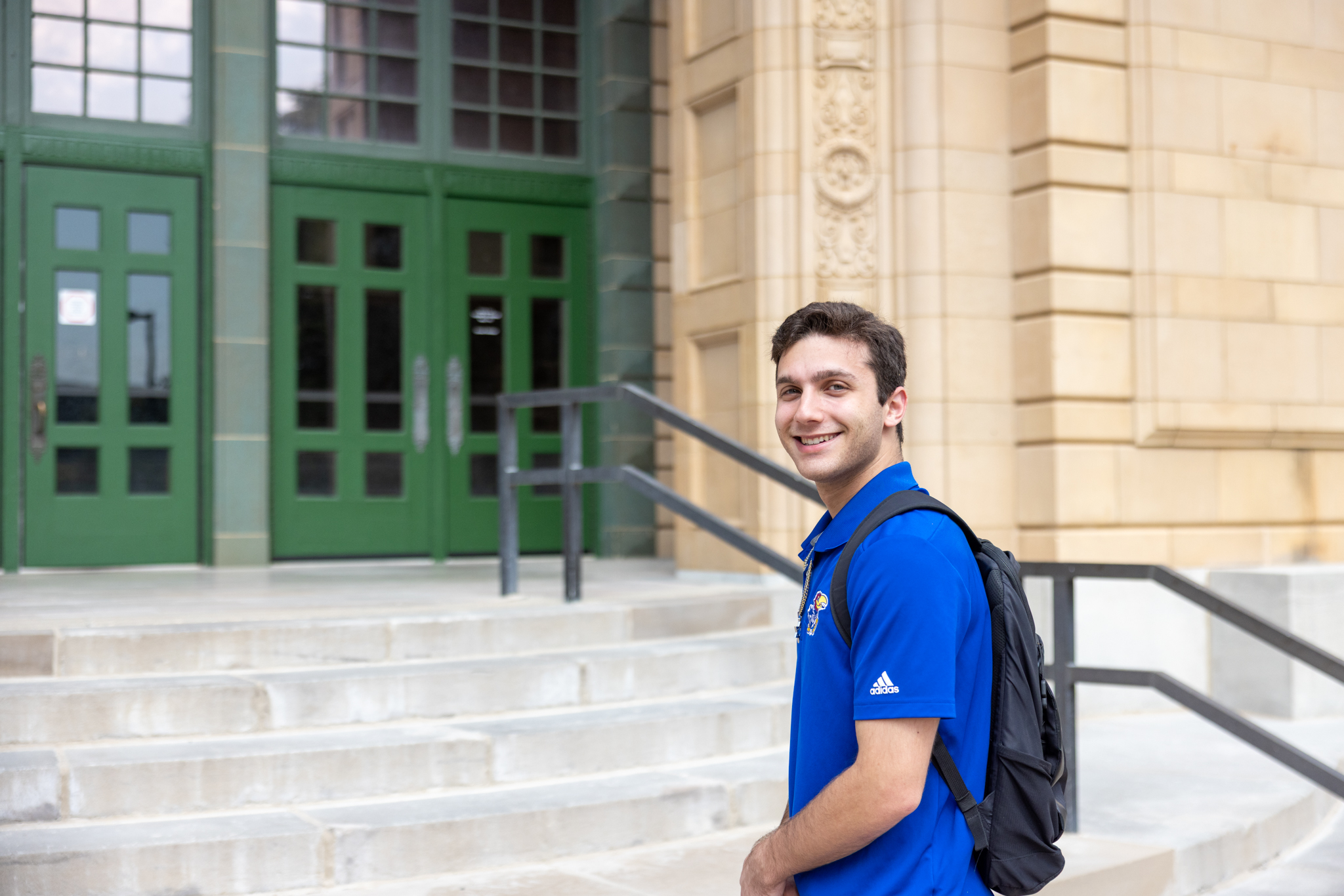 University of Kansas student ambassador Charles Lachman on the steps of Strong Hall.
