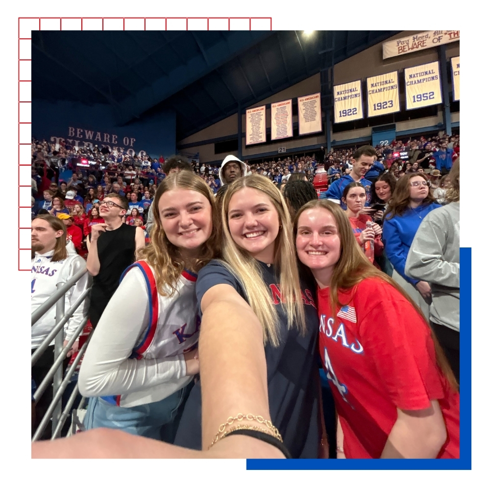 University of Kansas students pose for a selfie at Allen Fieldhouse for a basketball game.