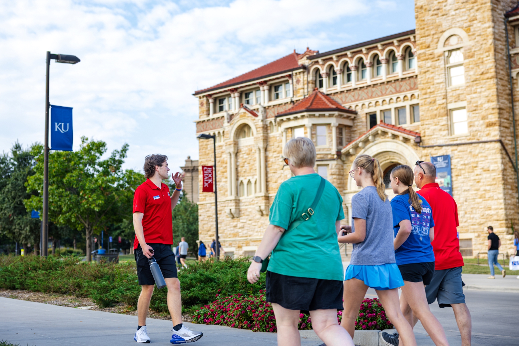 Student ambassador Jackson Fries takes future University of Kansas students on a KU campus tour.