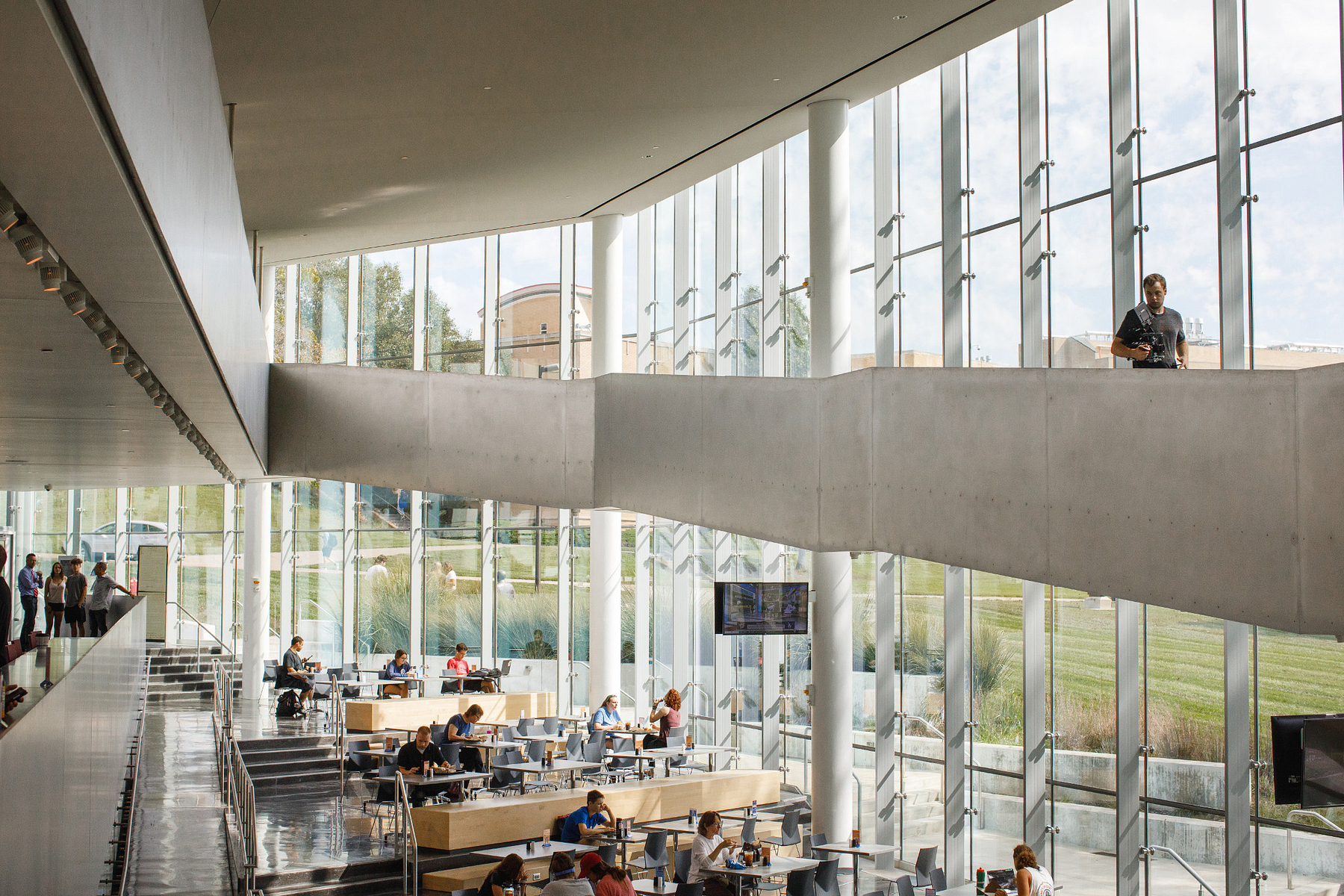 An overview image of the KU campus tour of the Debruce Center, filled with students studying and gathering for meals.