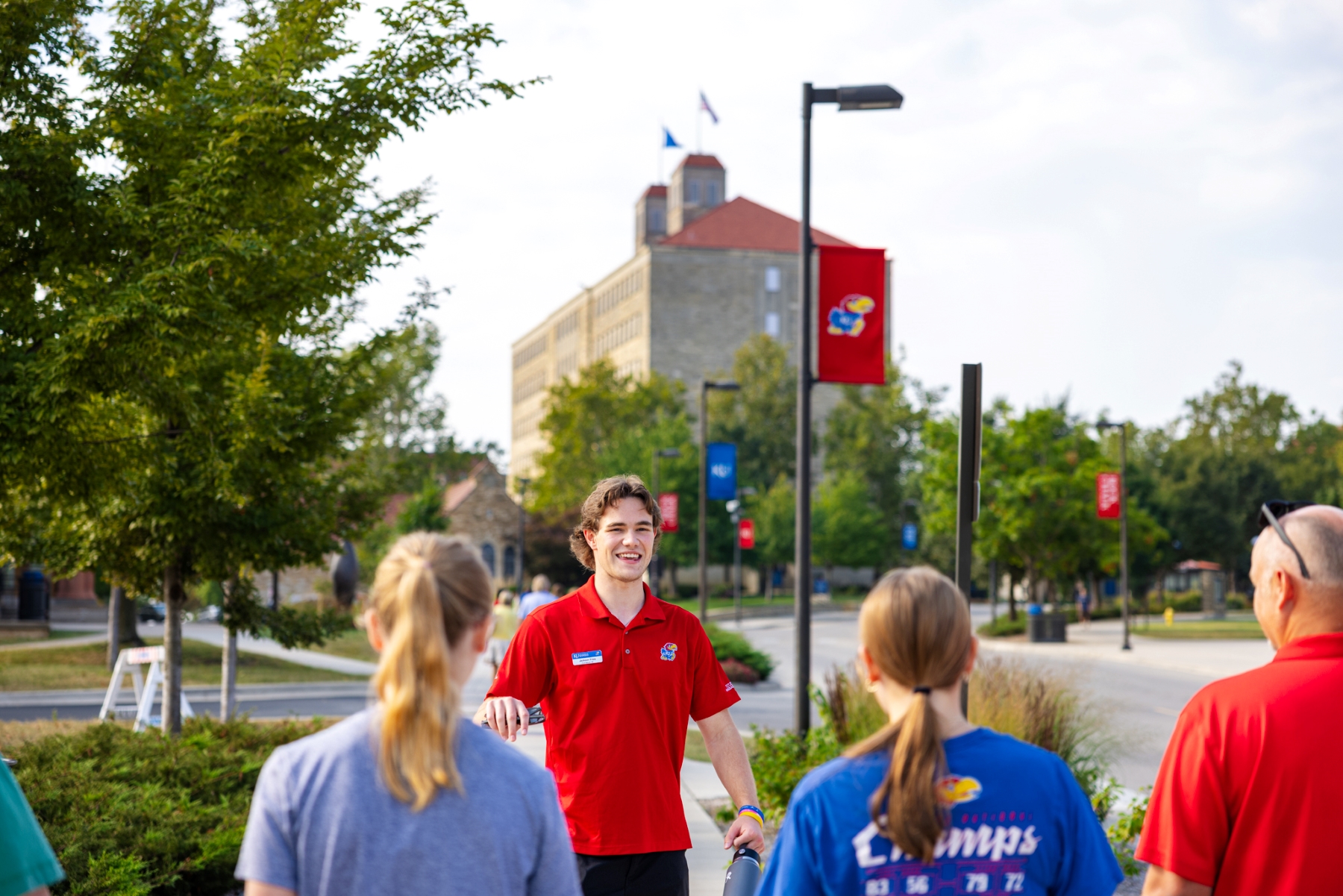Student ambassador Jackson Fries takes future University of Kansas students on a KU campus tour.