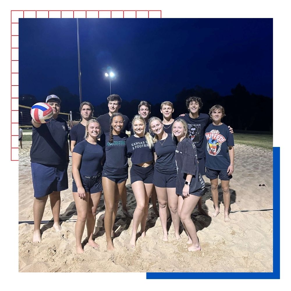University of Kansas students participating in an intramural sand volleyball game.