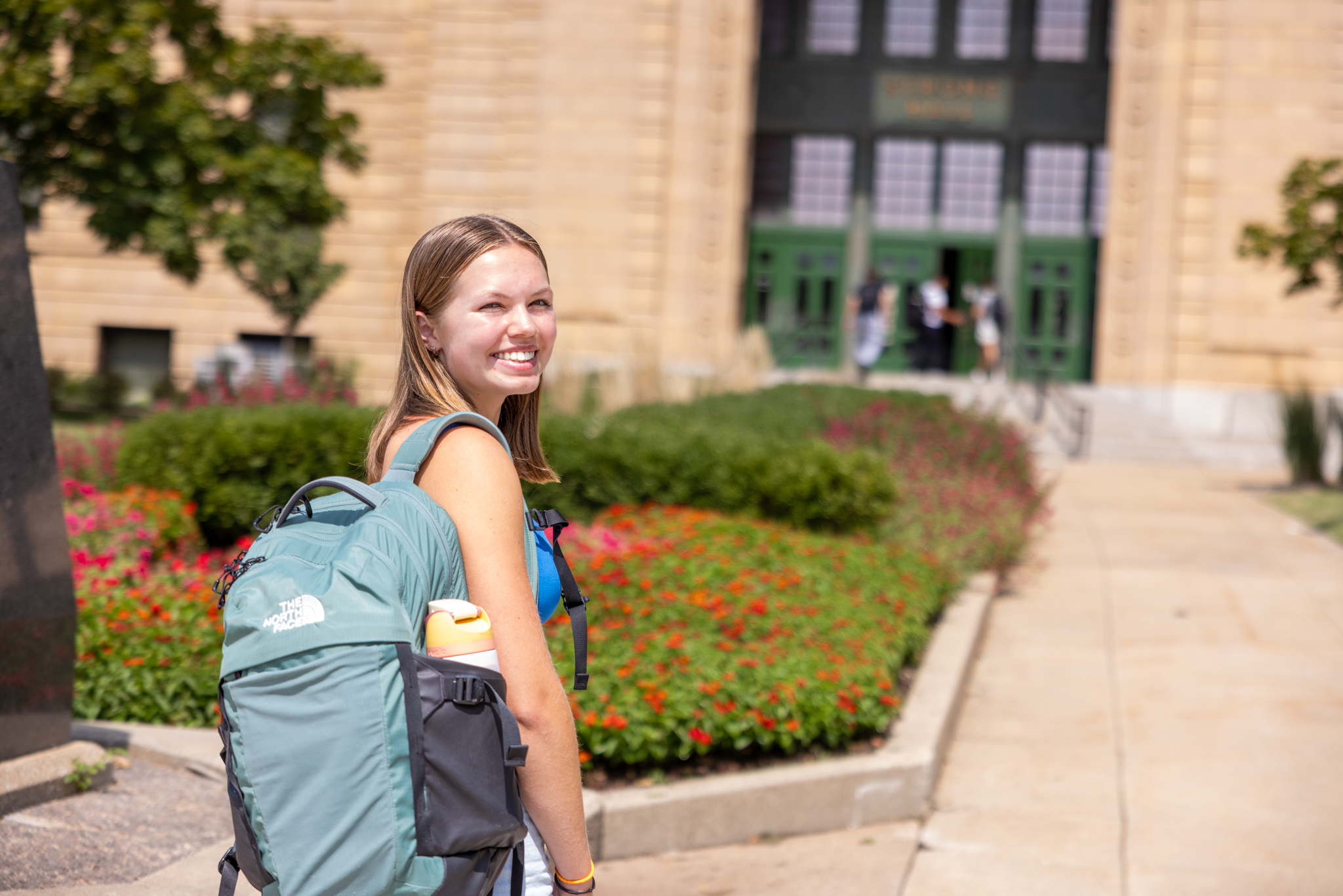 University of Kansas honors student Sydney Wynia on campus in front of Strong Hall