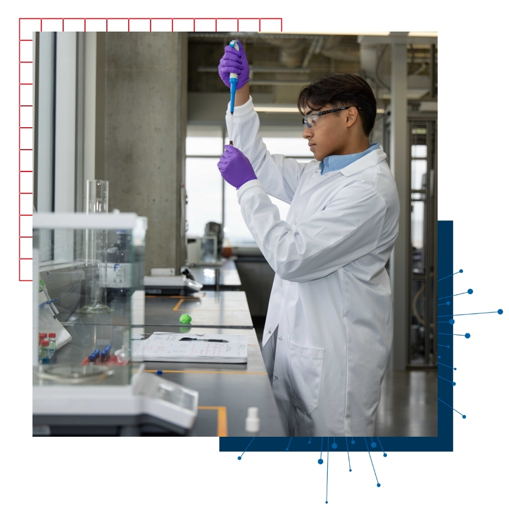 University of Kansas undergraduate researcher Pritam Ray looks at a test tube in a lab. 