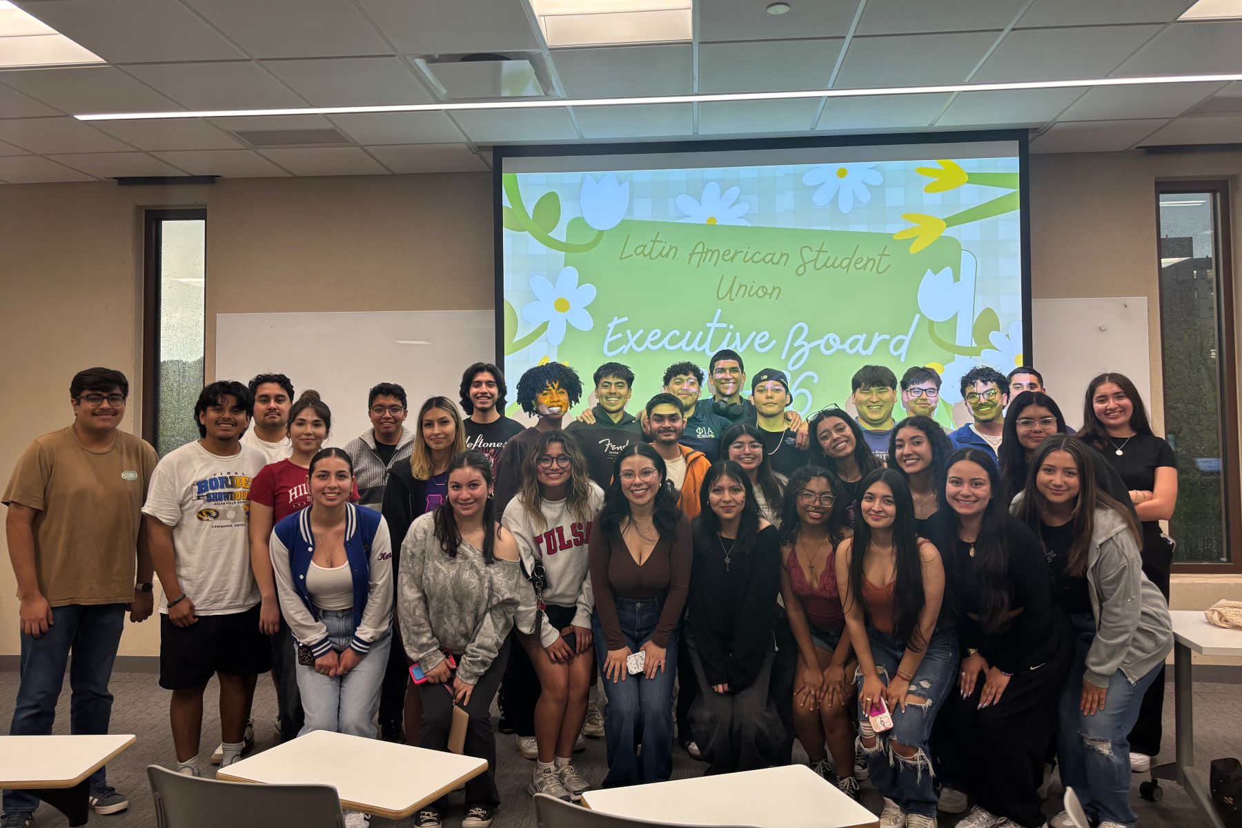 The executive board of the Latin American Student Union at KU gathers in a classroom for a meeting. 