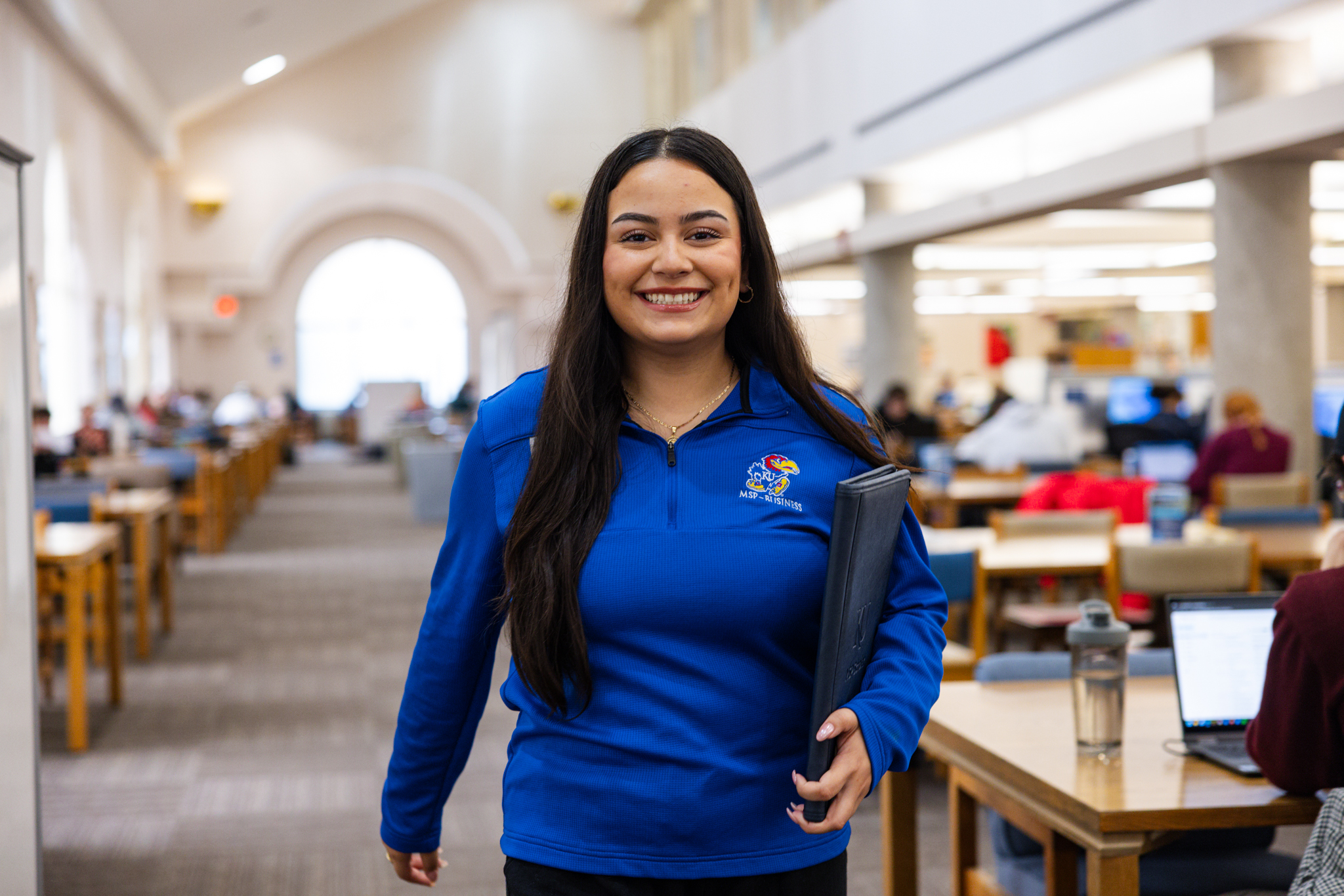 University of Kansas student Annalia Esalante is pictured walking in the Anschutz Library.