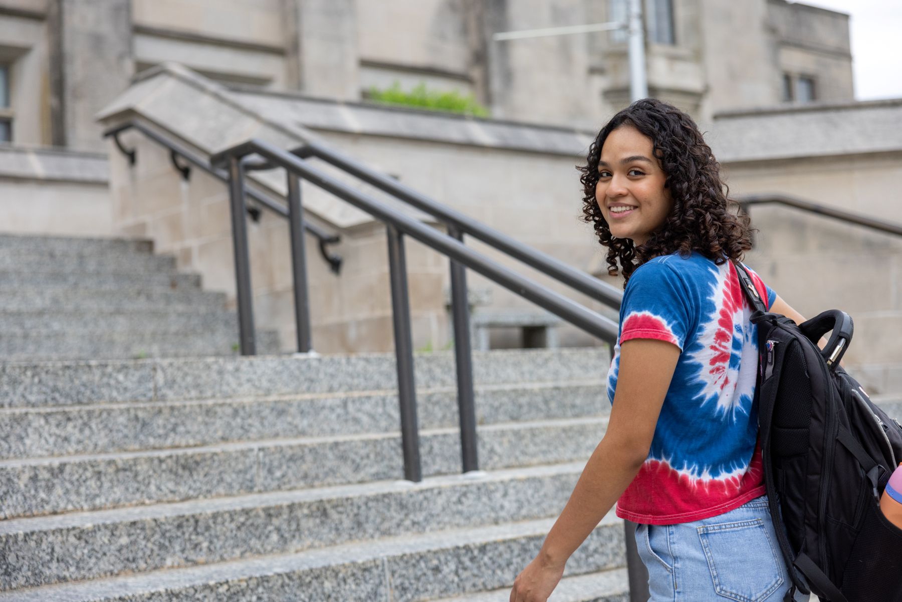 University of Kansas international student, Ana Pineda of Honduras, walks up the steps outside Watson Library on the KU campus.