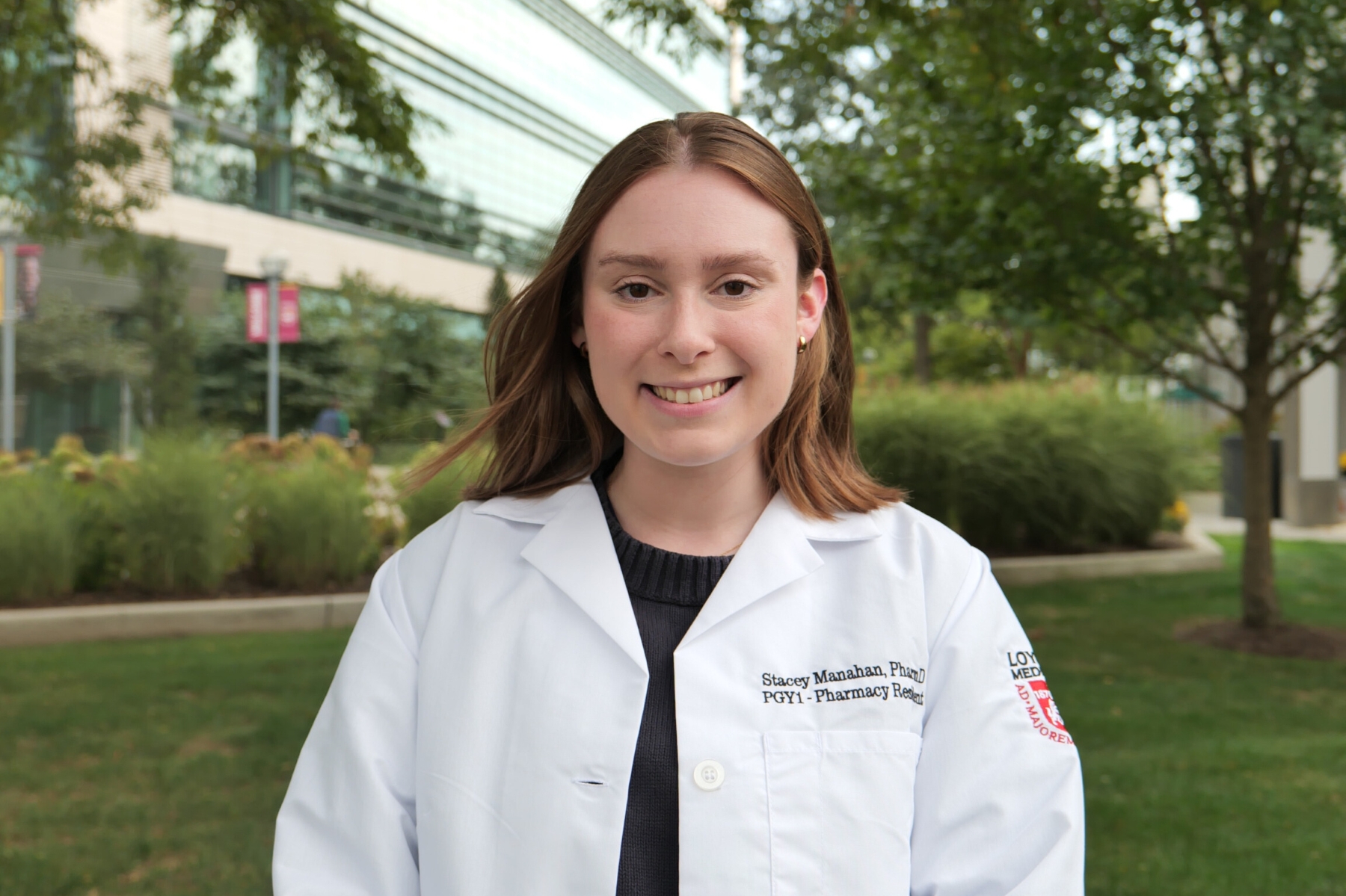 University of Kansas School of Pharmacy student Stacey Manahan poses for a portrait in her white pharmacy lab coat.