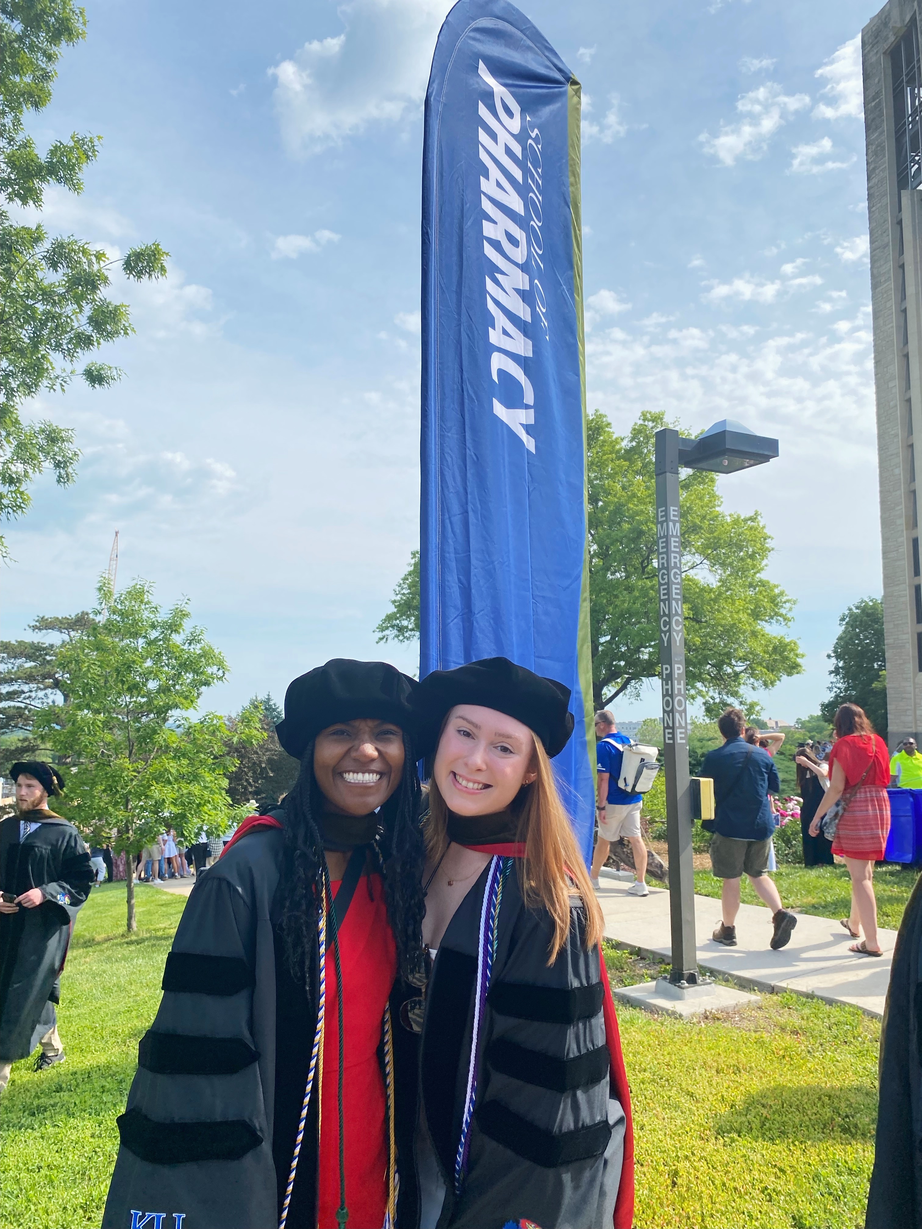 KU School of Pharmacy graduates gather beneath the Campanile on graduation day.