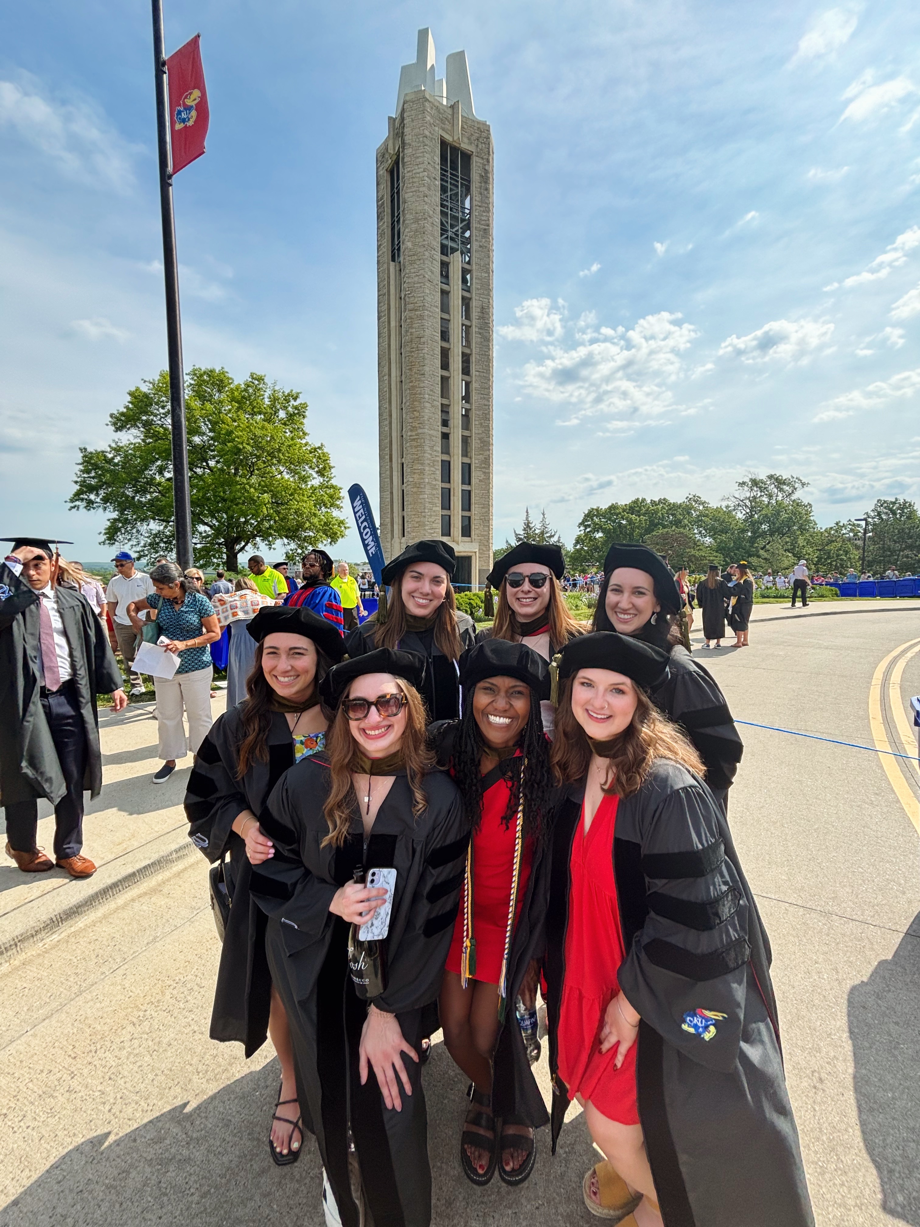 KU School of Pharmacy graduates gather beneath the Campanile on graduation day.