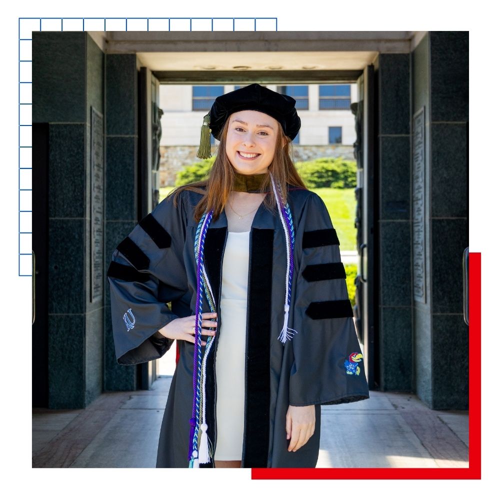 Out of state KU School of Pharmacy student Stacey Manahan poses in her graduation garb on campus.