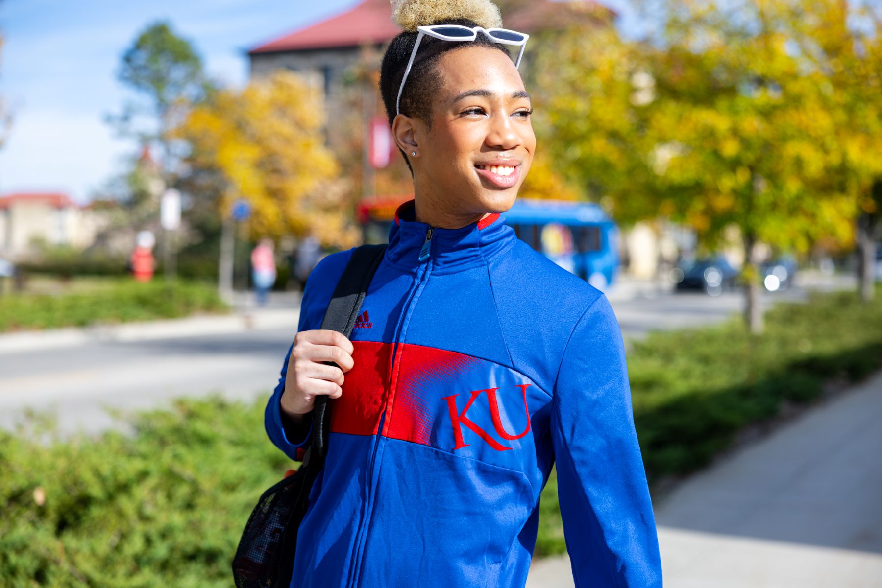 KU student Joshua Alston walks on campus in front of Wescoe Beach. 