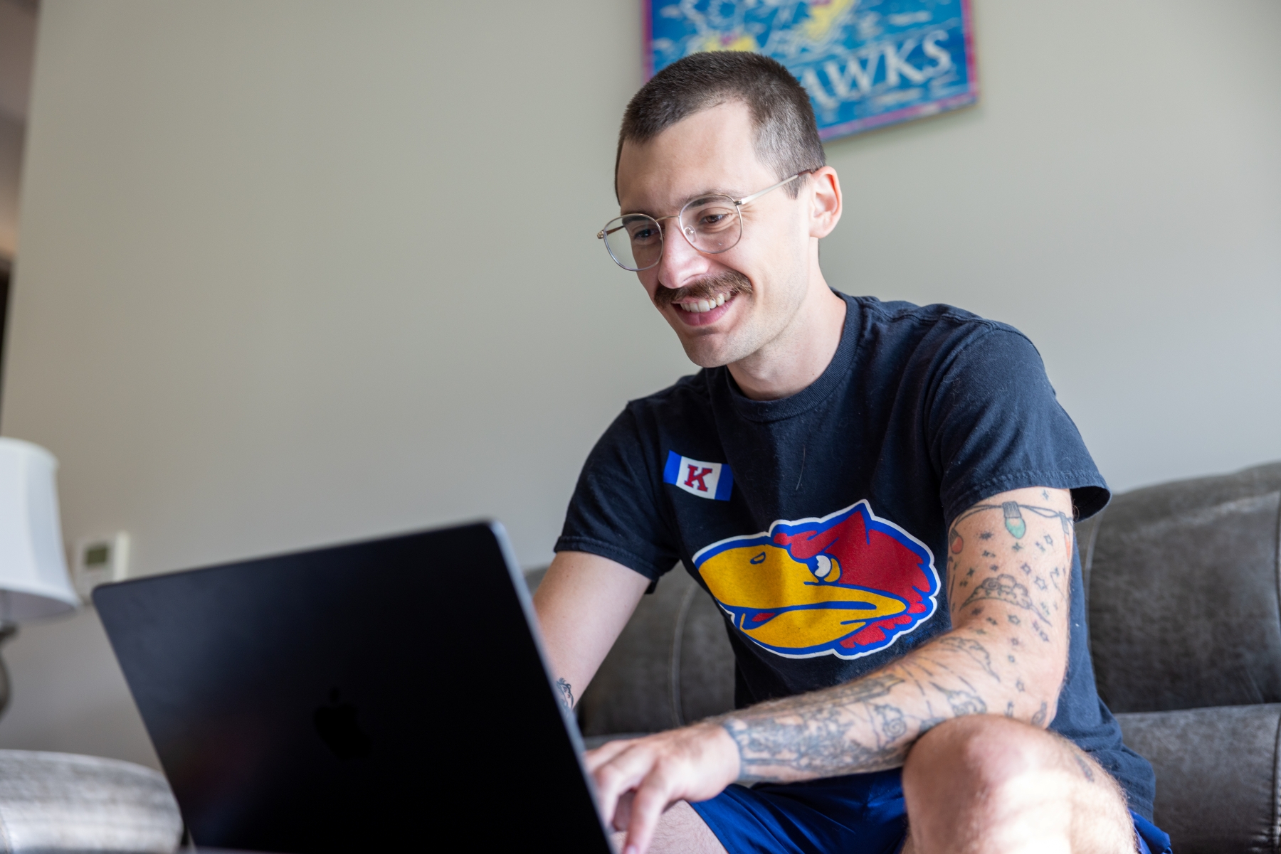 A University of Kansas KU Online graduate student studies in his home.