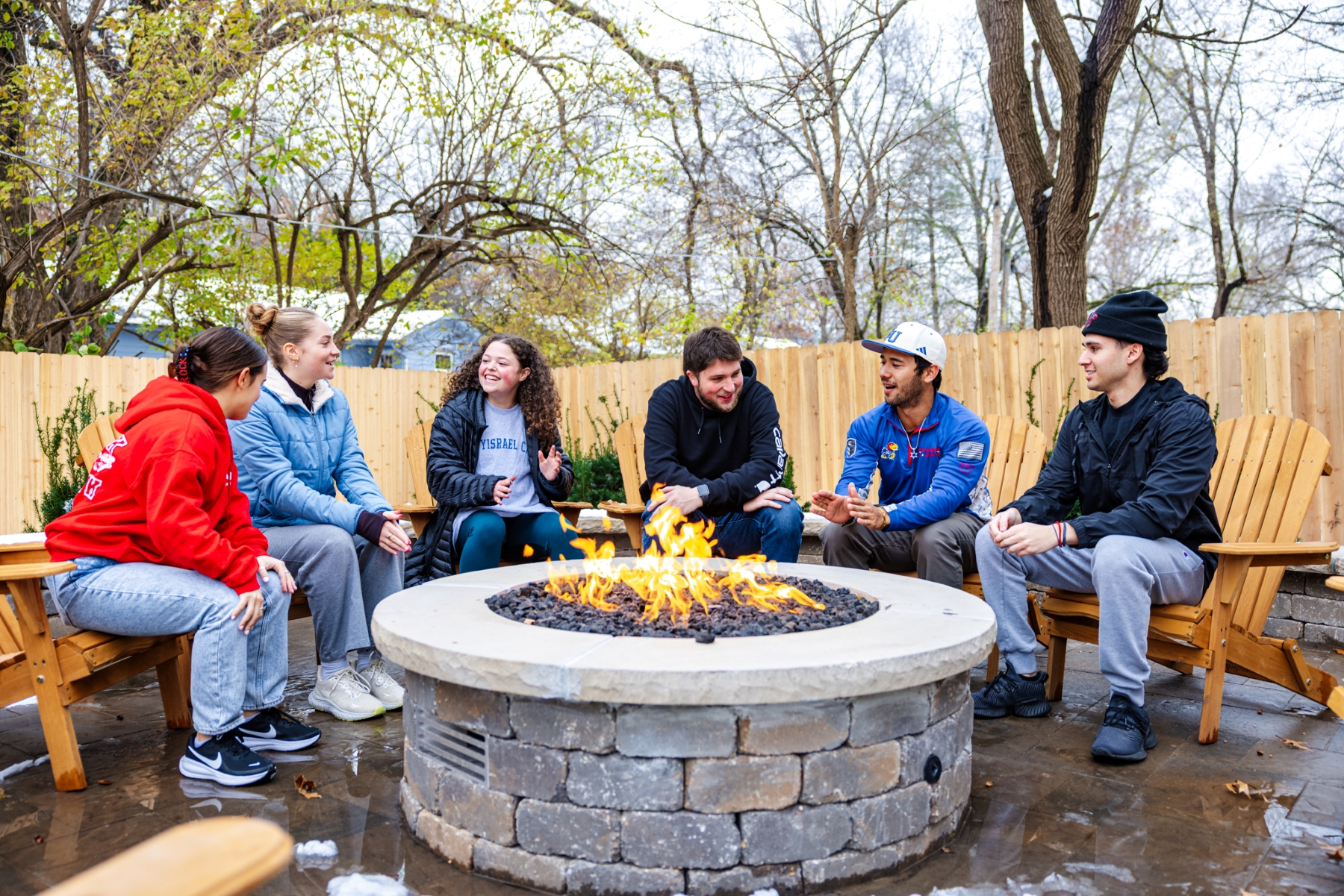 KU students gather around a firepit at the new Chabad Student Center on the University of Kansas campus.