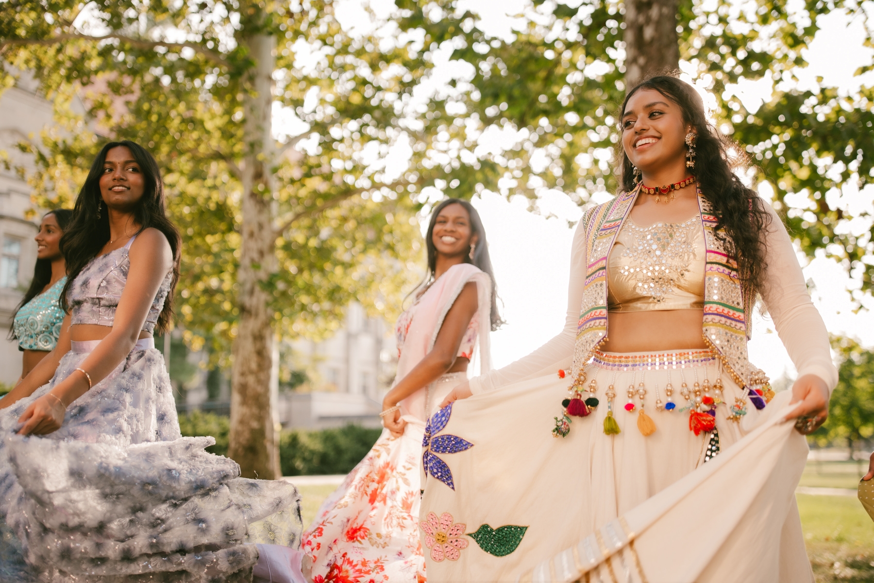 The University of Kansas Jeeva Bollywood dance team gathers for team photos on the lawn of Watson Library on the KU campus.