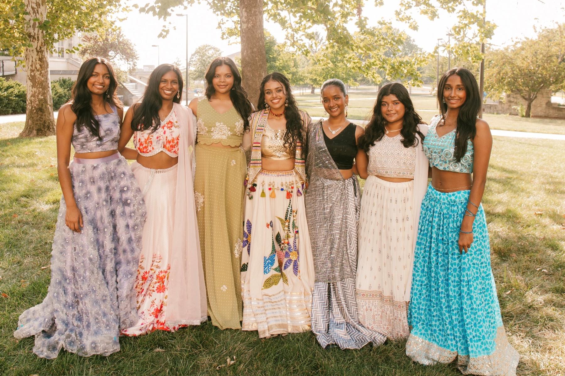 The University of Kansas Jeeva Bollywood dance team gathers for team photos on the lawn of Watson Library on the KU campus.