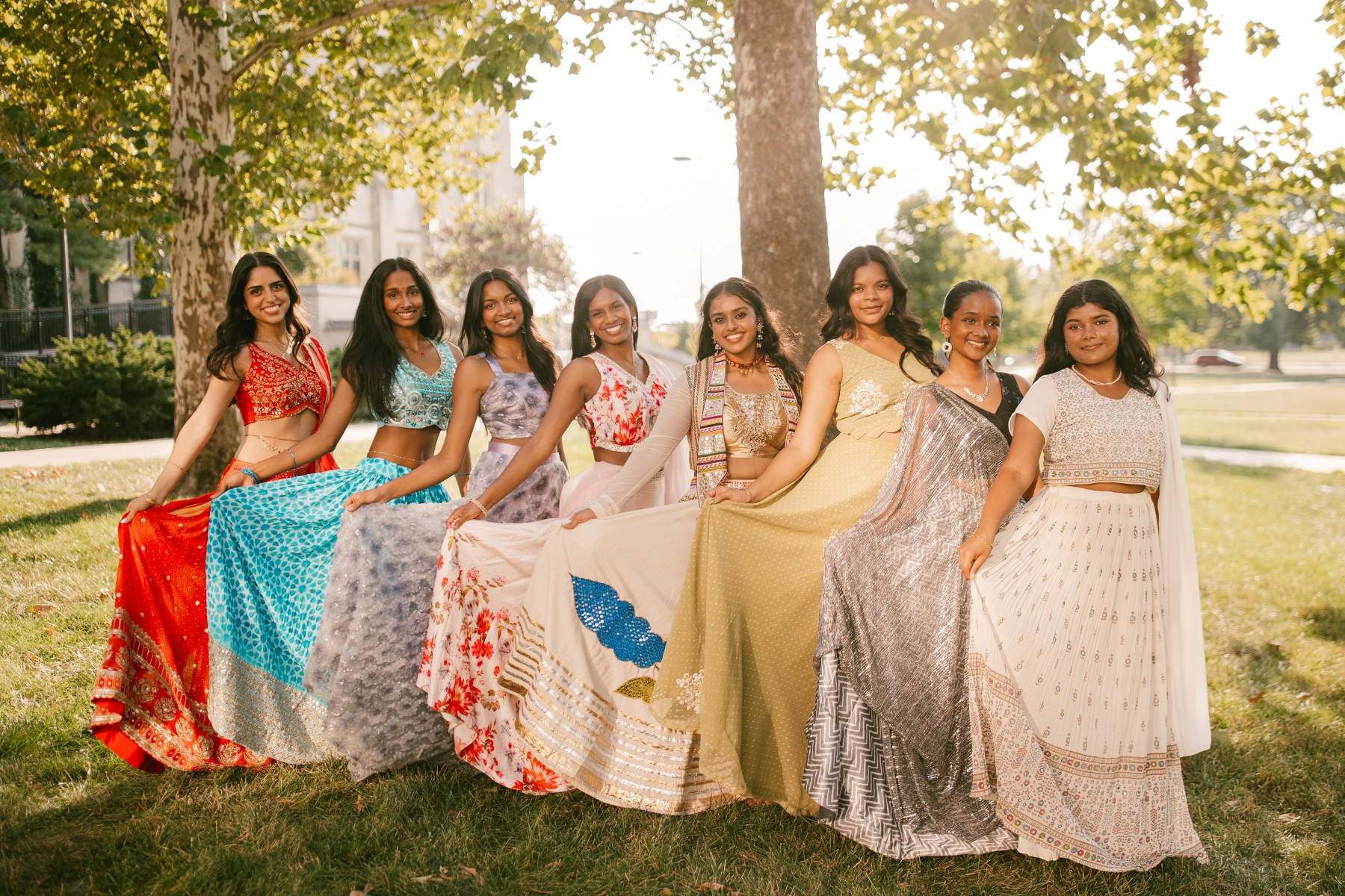 The University of Kansas Jeeva Bollywood dance team gathers for team photos on the lawn of Watson Library on the KU campus.