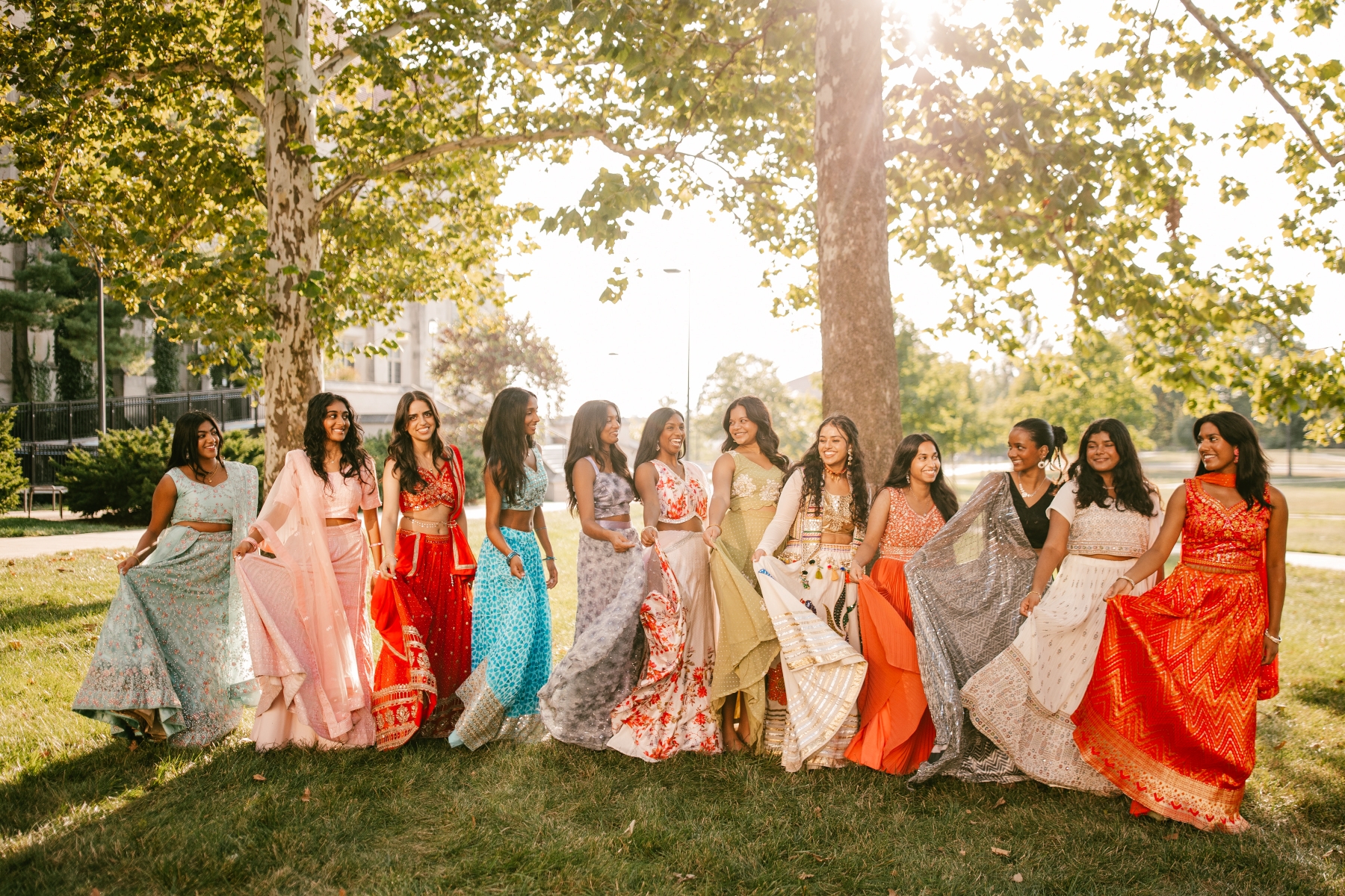 The University of Kansas Jeeva Bollywood dance team gathers for team photos on the lawn of Watson Library on the KU campus.
