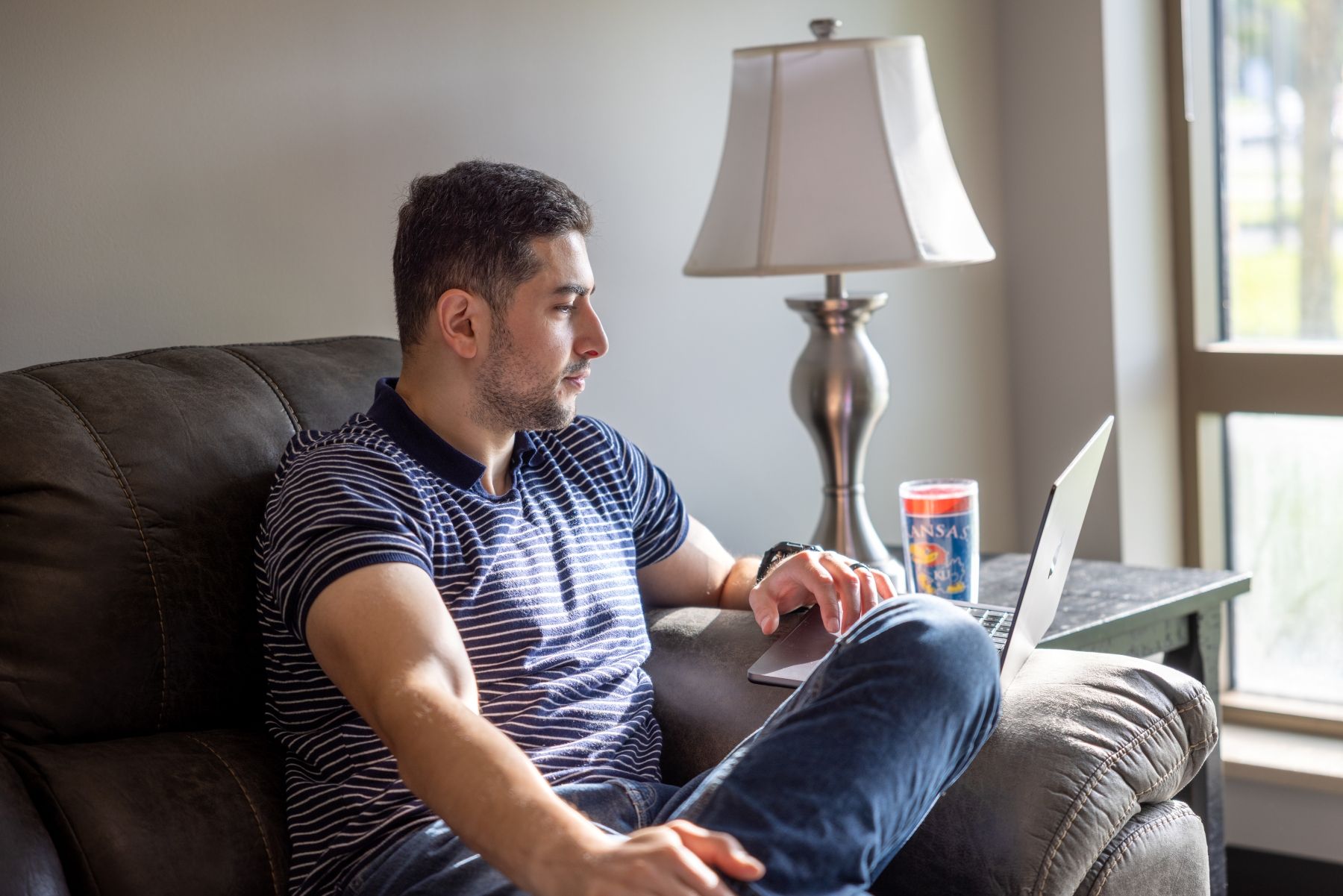 A KU graduate student in a professional degree program studies at a laptop.