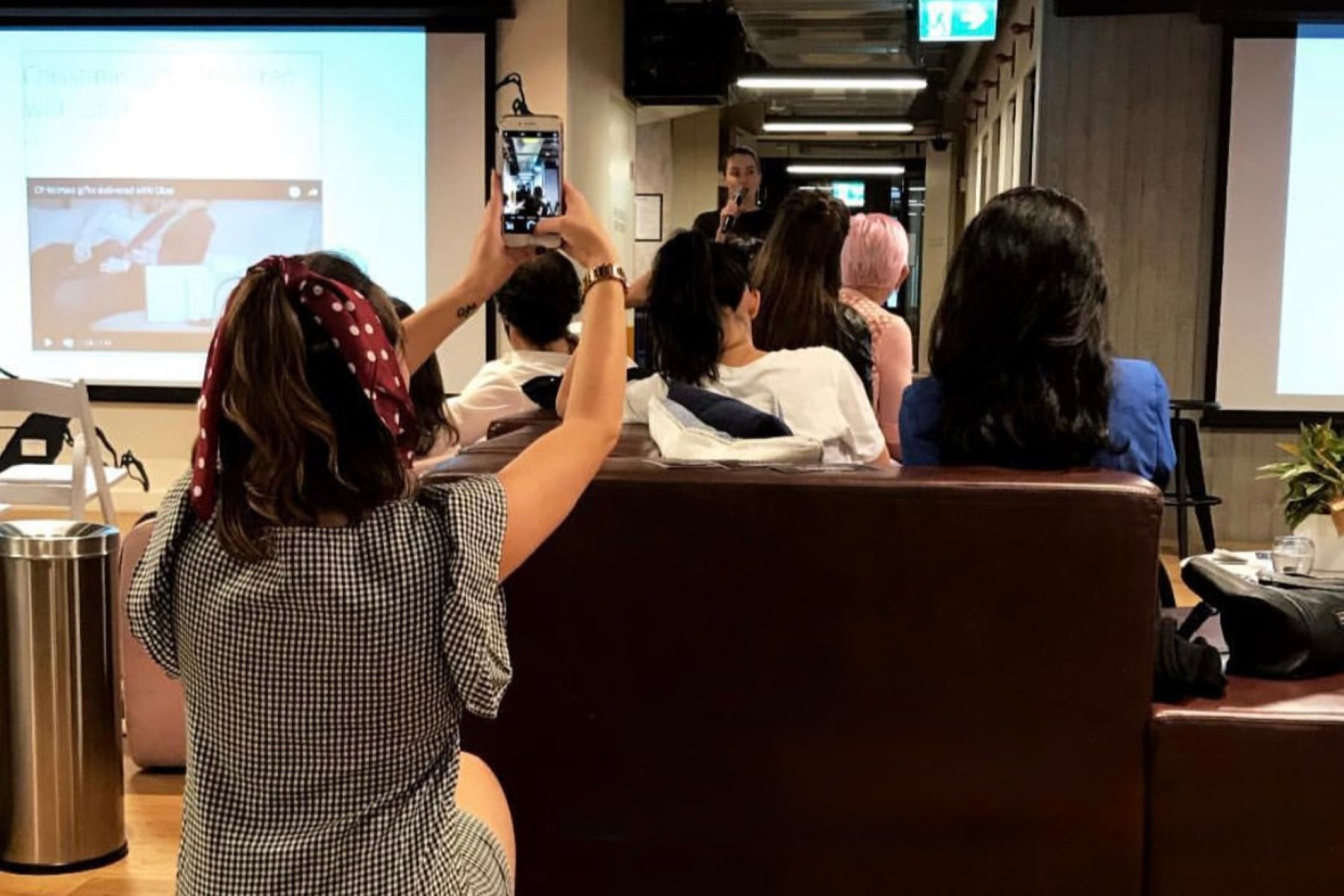 University of Kansas alumna Katie Morris captures iphone footage at an event for her social media director job.