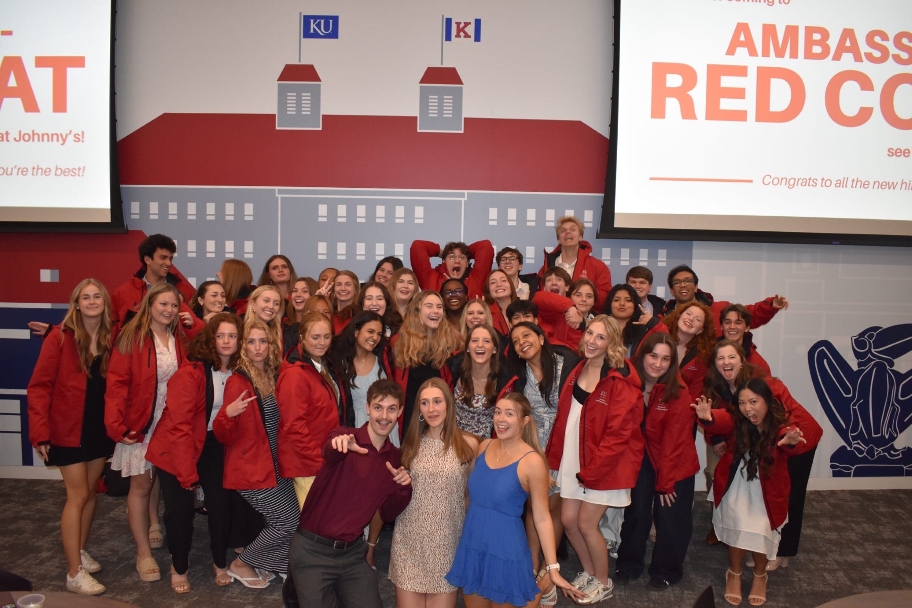University of Kansas student ambassadors pose for a group photo at their red coat ceremony. 
