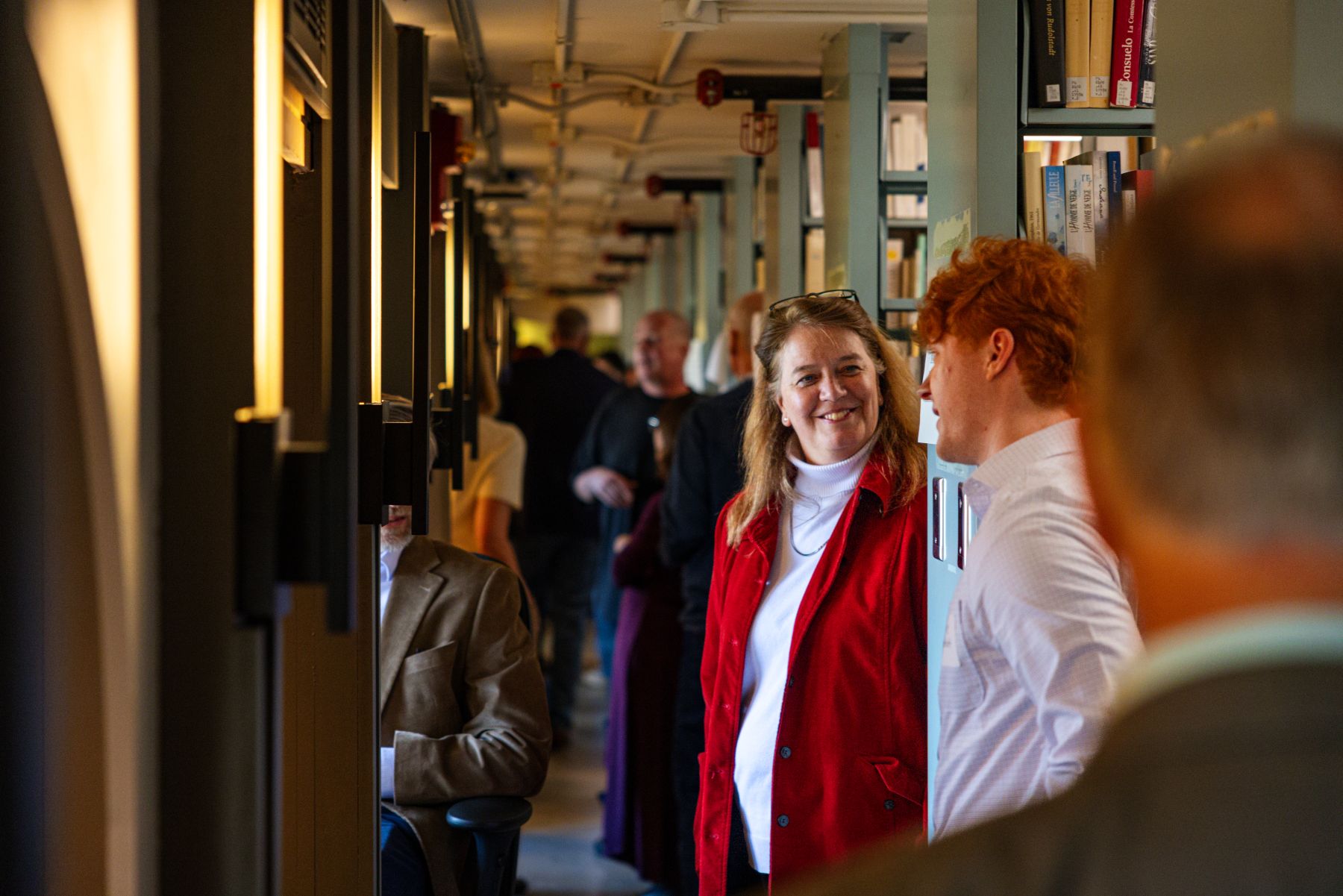 KU student talks to an advisor in the stacks of Watson Library