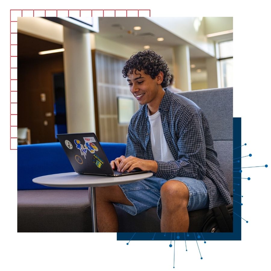 University of Kansas transfer student Steven Ibrahim works at a laptop in KU's Capitol Federal School of Business building. 