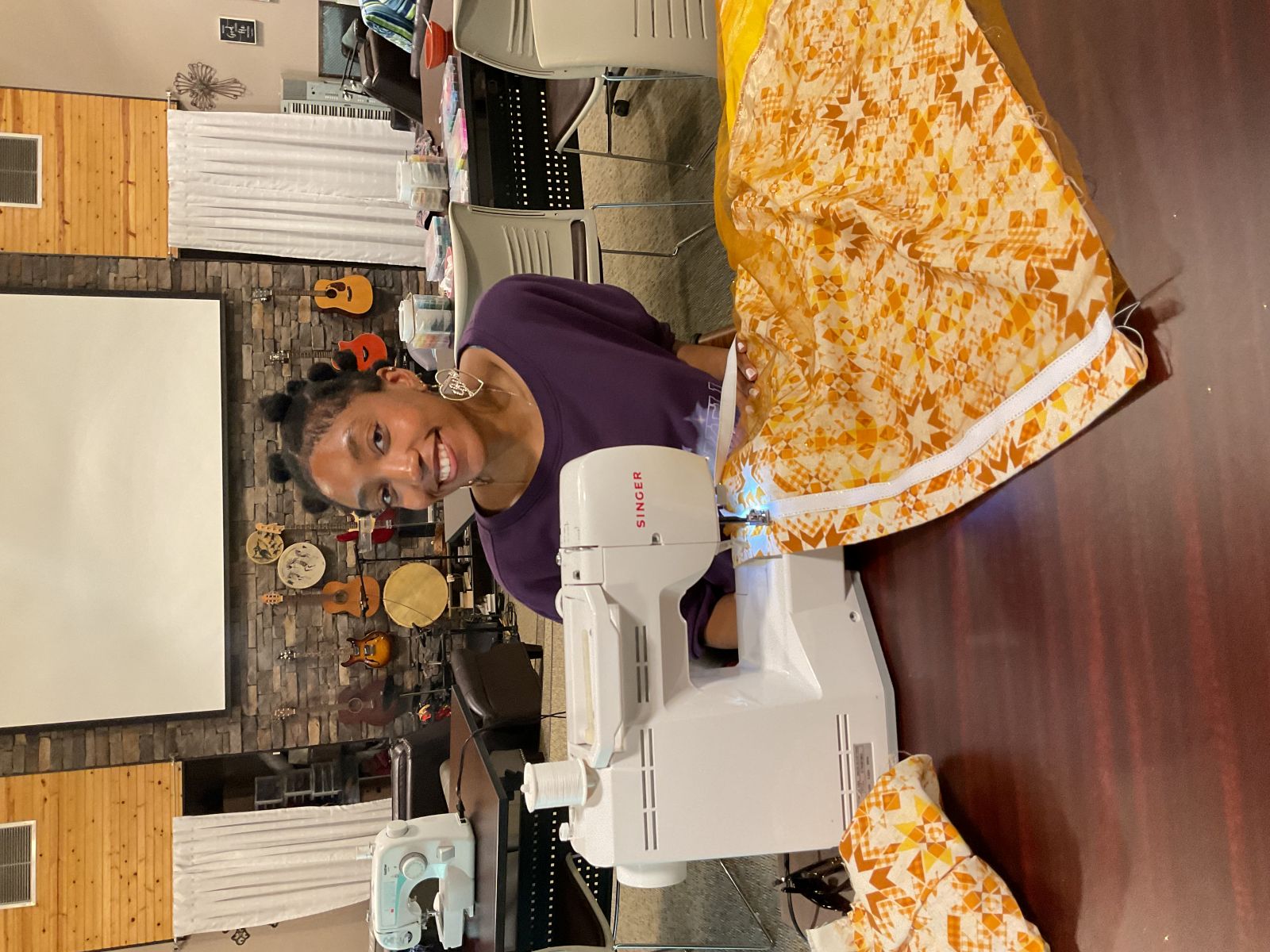 University of Kansas Indigenous Studies Master's degree student Lauryn Callis at a sewing machine working on a clothing project.