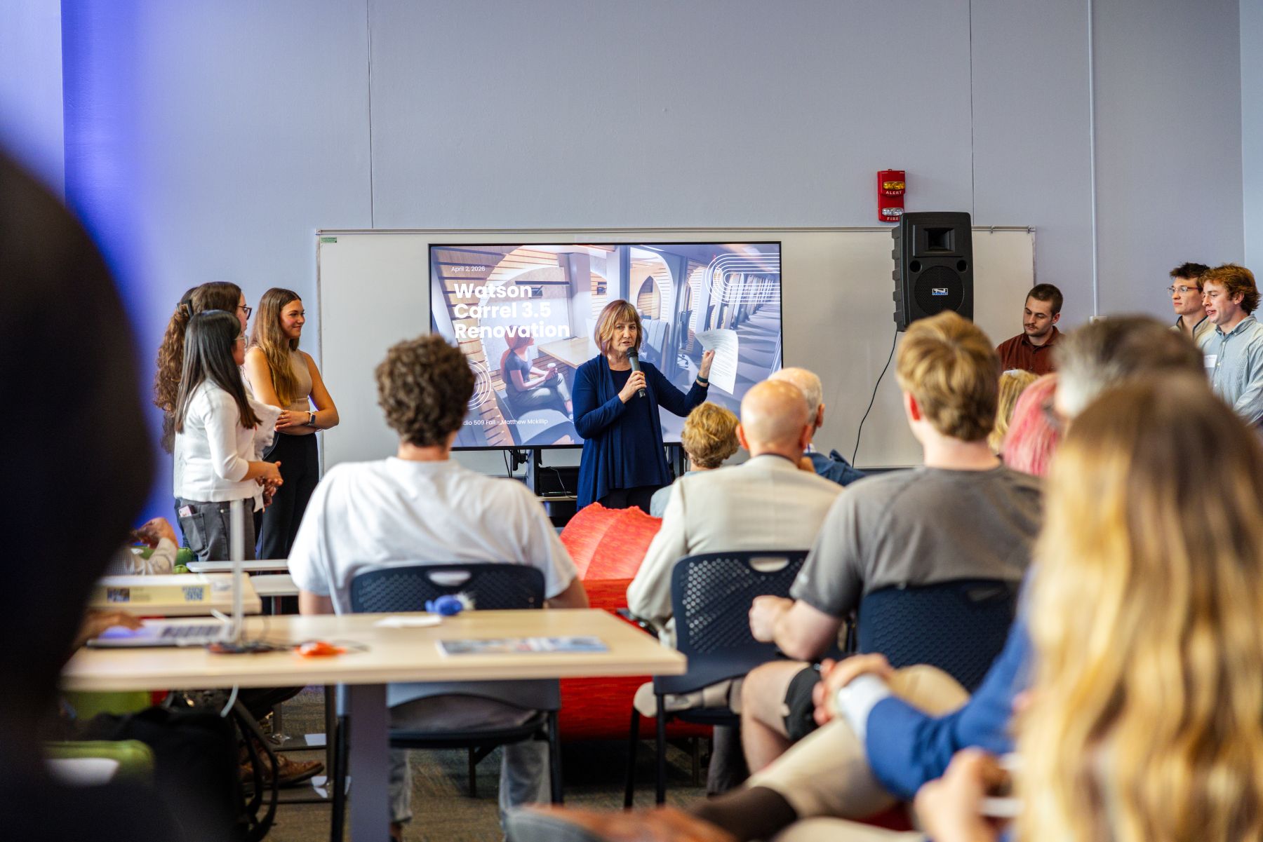 A classroom full of students watches a presentation during an KU academic unit visit to a high school 