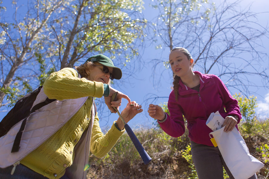 Student and professor in the field on an autumn day